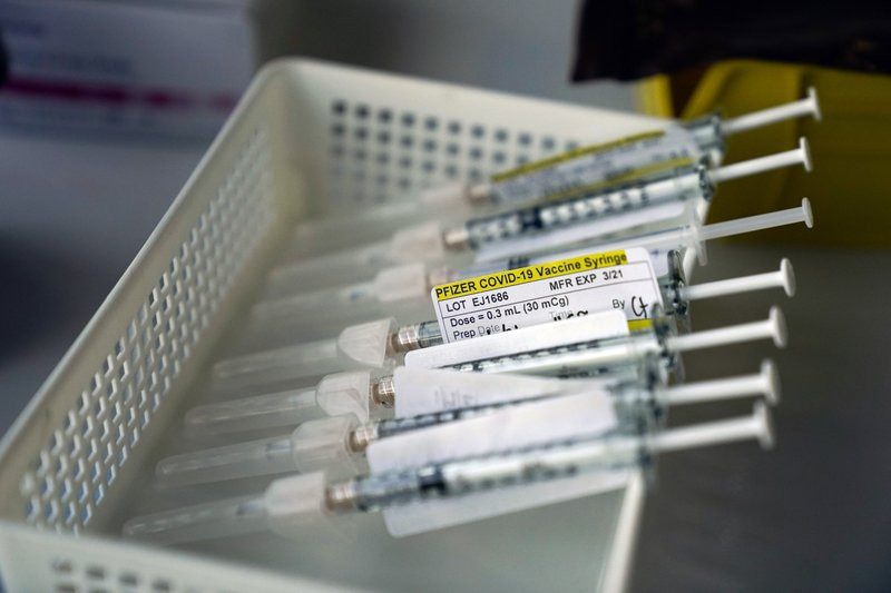 Syringes containing the Pfizer-BioNTech COVID-19 vaccine sit in a tray in a vaccination room at St. Joseph Hospital in Orange, Calif., Thursday, Jan. 7, 2021.