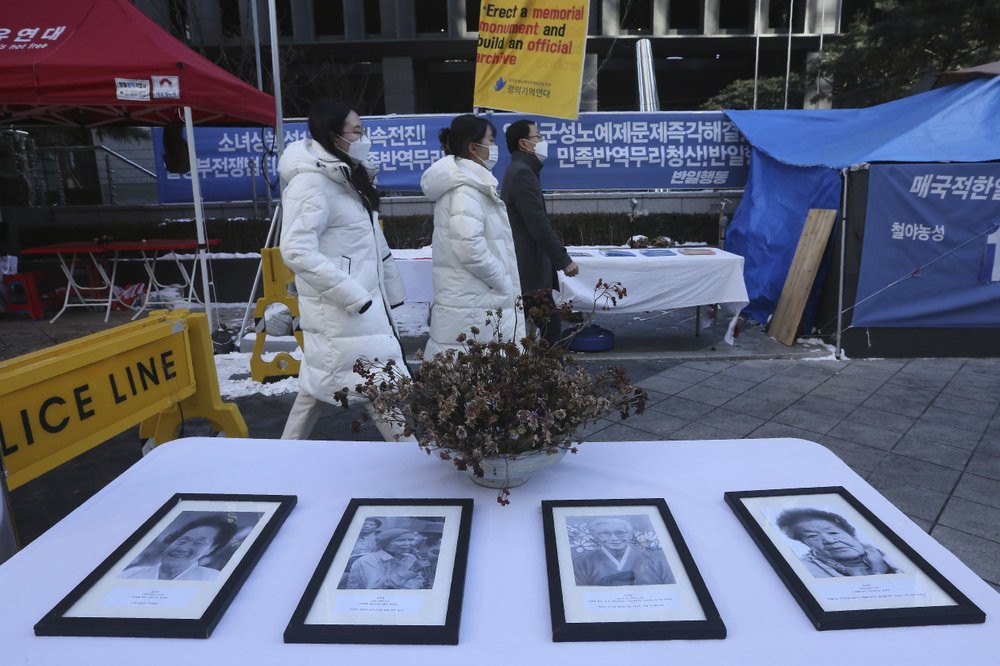 Portraits of late former South Korean comfort women are displayed near the Japanese Embassy in Seoul, South Korea, Friday, Jan. 8, 2021.