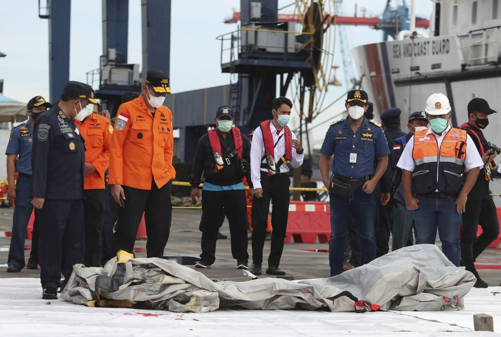 Rescuers inspect debris found in the waters around the location where a Sriwijaya Air passenger jet has lost contact with air traffic controllers shortly after the takeoff, at the search and 