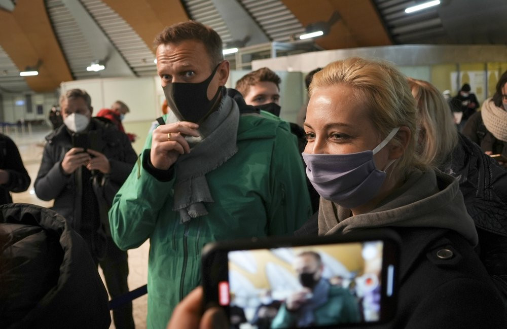 Alexei Navalny and his wife Yuliastand in line at the passport control after arriving at Sheremetyevo airport, outside Moscow, Russia, Sunday, Jan. 17, 2021.