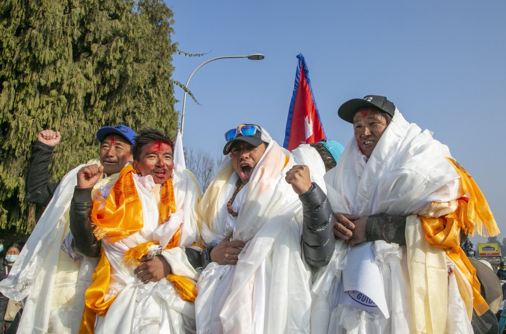 The all-Nepalese mountaineering team that became the first to scale Mount K2 in winter cheer as they arrive at Tribhuwan International airport in Kathmandu, Nepal, Tuesday, Jan. 26, 2021.