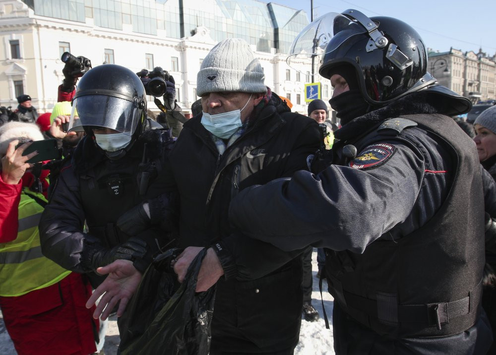 Police officers detain a man during a protest against the jailing of opposition leader Alexei Navalny in Vladivostok, Russia, on Sunday, Jan. 31, 2021.
