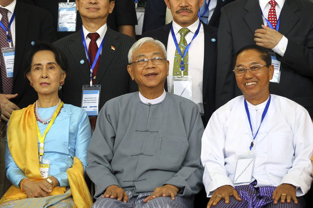 In this May 24, 2017, file photo, Myanmar's Vice President Myint Swe, right, smiles while sitting with State Counsellor Aung San Suu Kyi, left, and then President Htin Kyaw.