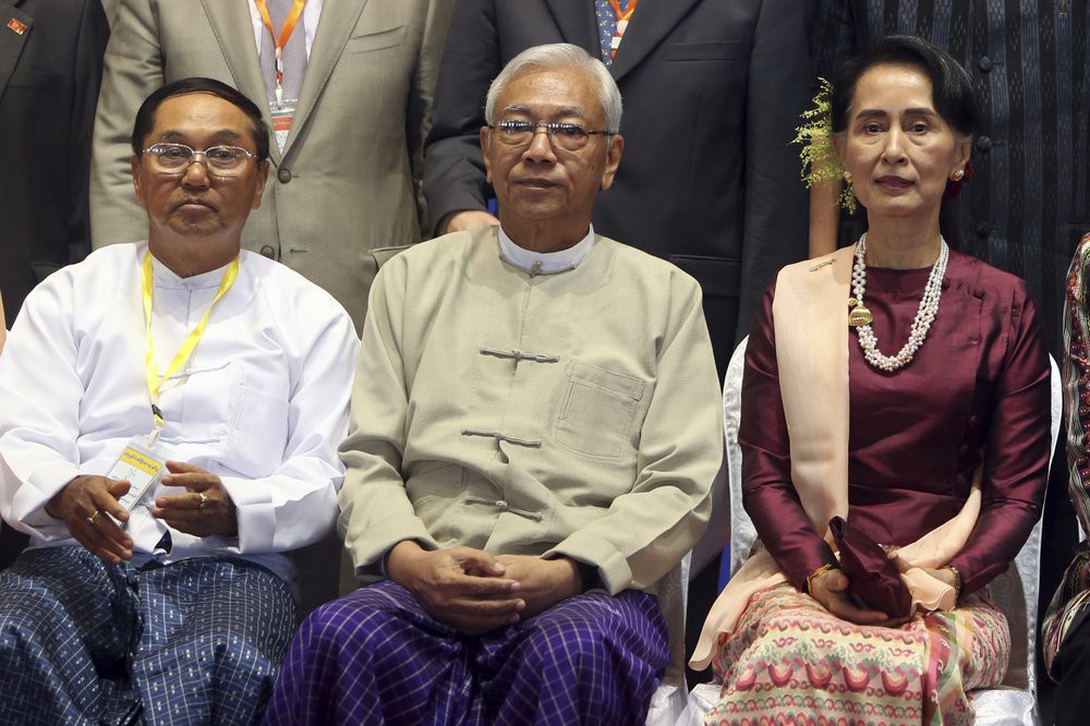 In this Oct. 15, 2017, file photo, Myanmar's Vice President Myint Swe, left, sits with State Counsellor Aung San Suu Kyi, right, and then President Htin Kyaw, for a photo session.