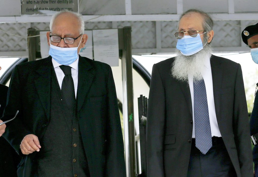 Ahmed Saeed Sheikh, right, father of British-born Pakistani Ahmed Omar Saeed Sheikh, leaves with his lawyer Rauf A. Sheikh, following Daniel Pearl case hearing in the Supreme Court, in Islama