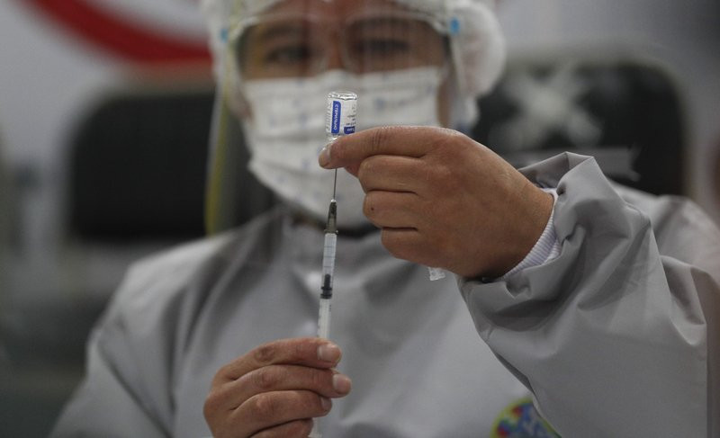A healthcare worker prepares a dose of Russia's Sputnik V COVID-19 vaccine, at the Del Norte Hospital in El Alto, Bolivia, Saturday, Jan. 30, 2021.