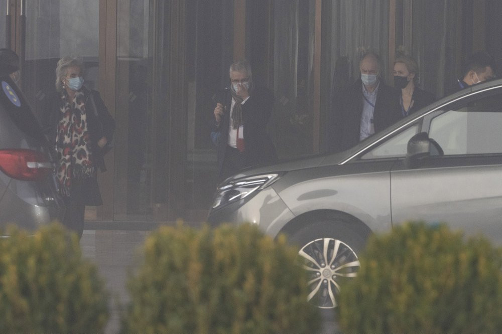 Members of a World Health Organization team leave their hotel on a foggy day for another day of field visit in Wuhan in central China's Hubei province on Wednesday, Feb. 3, 2021.