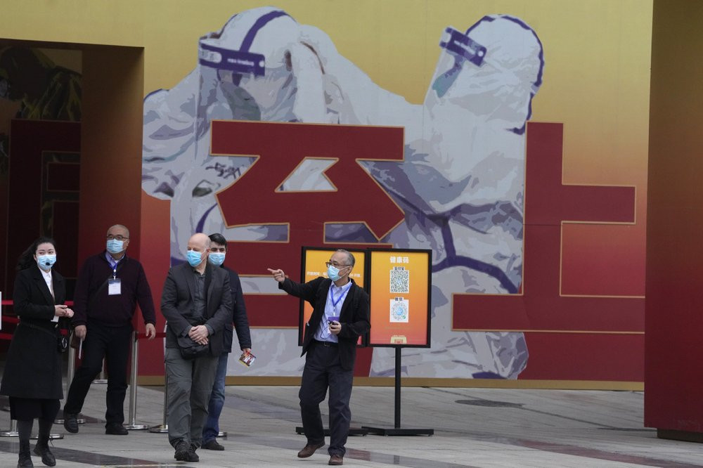 In this Jan. 30, 2021, file photo, members of the WHO team including Ken Maeda, center, Peter Daszak, third from left and Vladmir Dedkov, fourth from left, leave after attending an exhibition