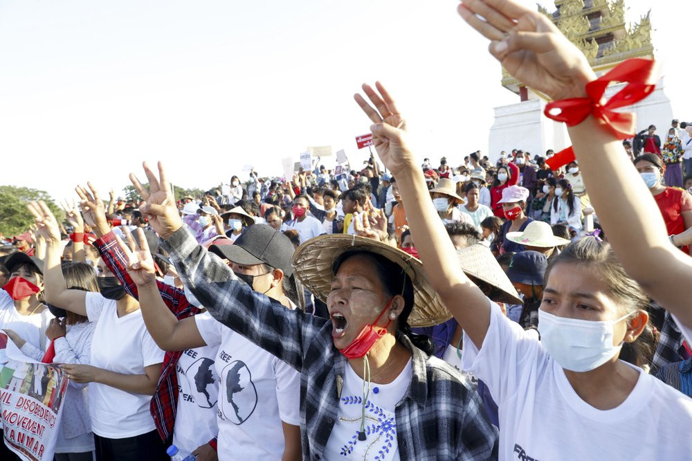 Demonstrators flash three-fingered salutes, a symbol of resistance, against the military coup and shout slogans calling for the release of detained Myanmar leader Aung San Suu Kyi during a pr