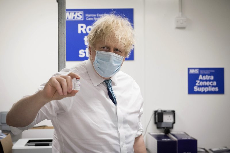 In this Monday, Jan. 25, 2021 file photo, Britain's Prime Minister Boris Johnson holds a vial of the Oxford AstraZeneca COVID-19 vaccine, during a visit to Barnet FC's ground at the Hive in L