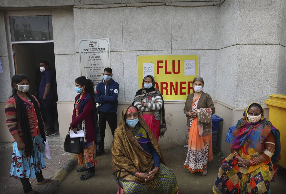 People wait outside a health center to get tested for COVID-19 in New Delhi, India, Thursday, Feb. 11, 2021.