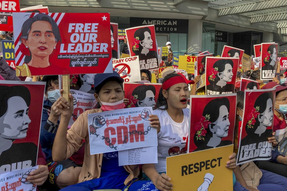 Demonstrators display images of detained Myanmar leader Aung San Suu Kyi during a protest against the military coup in Yangon, Myanmar, Tuesday, Feb. 16, 2021.