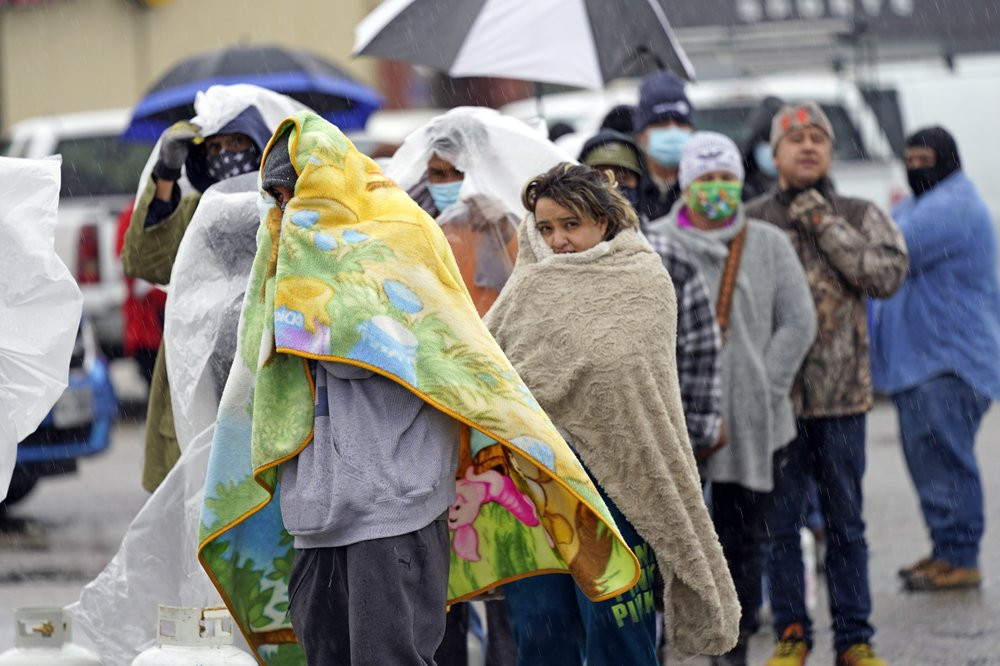 People wait in line to fill propane tanks Wednesday, Feb. 17, 2021, in Houston. Customers waited over an hour in the freezing rain to fill their tanks.