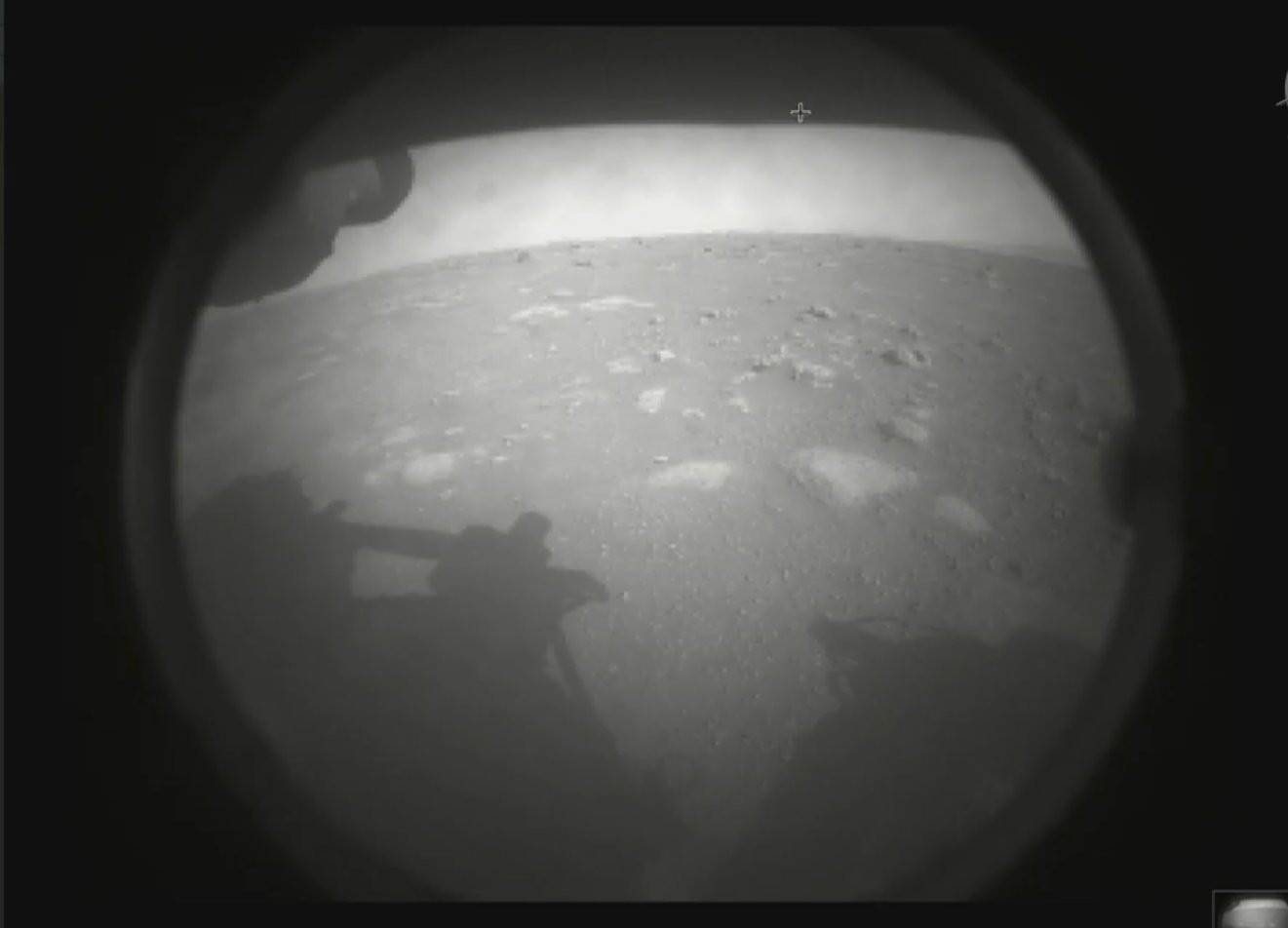 This photo made available by NASA shows the first image sent by the Perseverance rover showing the surface of Mars, just after landing in the Jezero crater, on Thursday, Feb. 18, 2021.