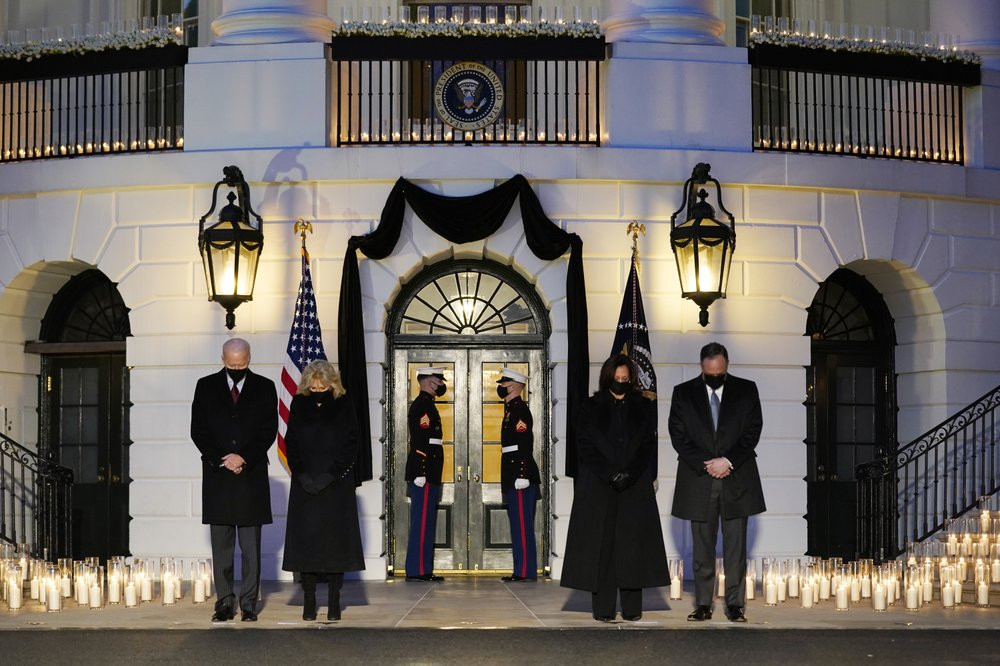 From left, President Joe Biden, First Lady Jill Biden, Vice President Kamala Harris and her husband Doug Emhoff, bow their heads during a ceremony to honor the 500,000 Americans that died fro