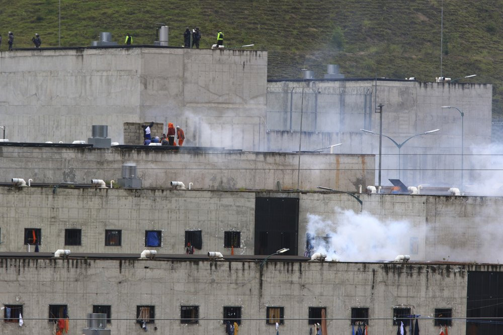 Tear gas rises from parts of Turi jail where an inmate riot broke out in Cuenca, Ecuador, Tuesday, Feb. 23, 2021.