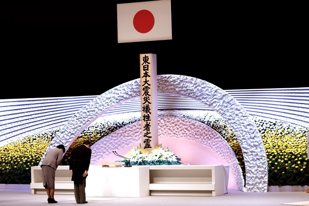 Japan's Emperor Naruhito, right, and Empress Masako bow in front of the altar for victims of the March 11, 2011 earthquake and tsunami at the national memorial service in Tokyo, Thursday, Mar