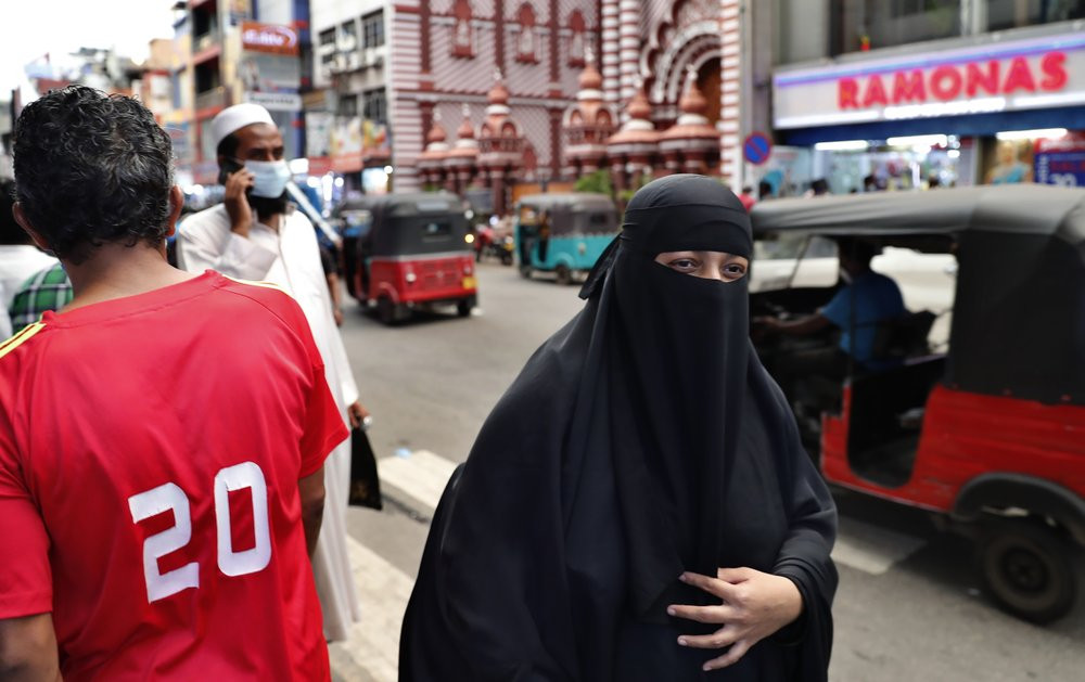 A burqa clad Sri Lankan Muslim woman walks in a street of Colombo, Sri Lanka, Saturday, March 13, 2021.