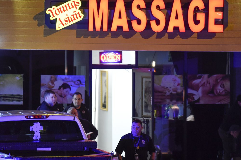Authorities investigate a fatal shooting at a massage parlor, late Tuesday, March 16, 2021, in Acworth, Georgia.