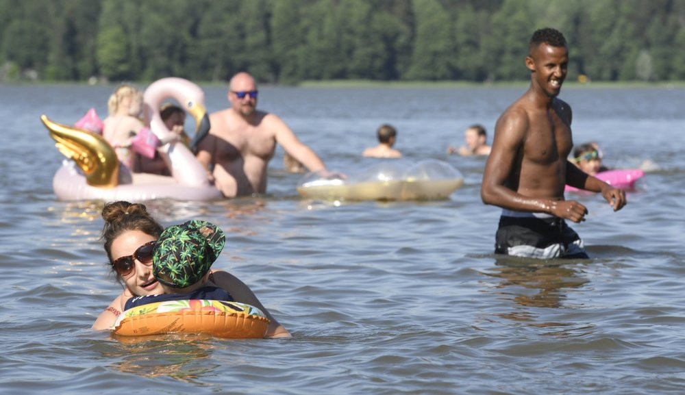 People enjoy hot summer day in a lake in Espoo, Finland, on June 26, 2020.