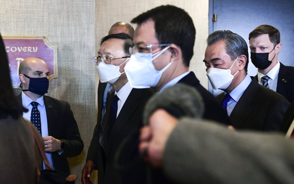 Chinese Communist Party foreign affairs chief Yang Jiechi, second from left, and China's State Councilor Wang Yi, second from right, depart the ballroom from the closed-door morning session o
