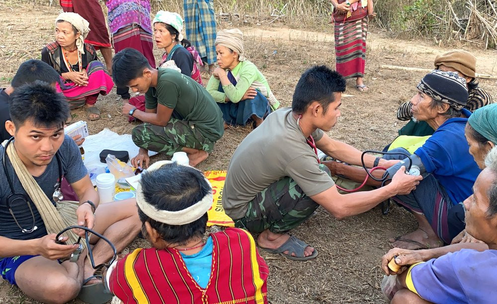 In this photo released by the Free Burma Rangers, members of the humanitarian group Free Burma Rangers carry out medical checkups on villagers in the northern Karen State, Myanmar Feb. 25, 20
