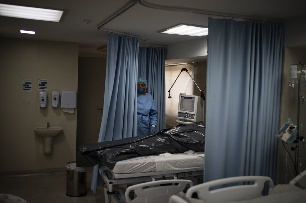 The body of a COVID-19 victim lies in a body bag at the ICU of the Sao Jose municipal hospital in Duque de Caxias, Brazil, Wednesday, March 24, 2021.