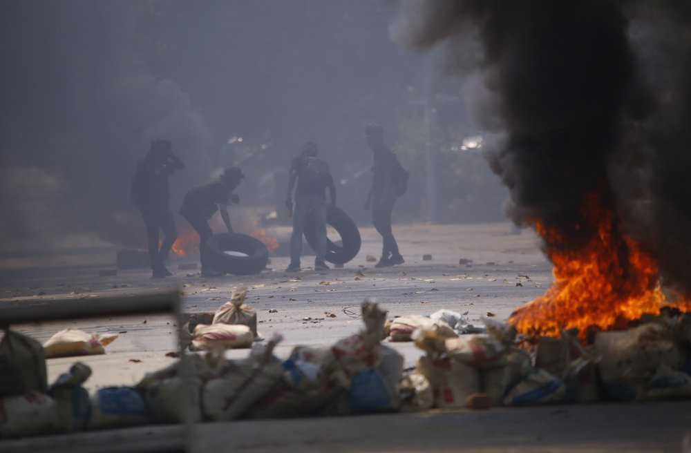 Protesters gather tires to add to the fires set during a rally against the military coup Saturday, March 27, 2021, in Tarmwe township in Yangon, Myanmar.