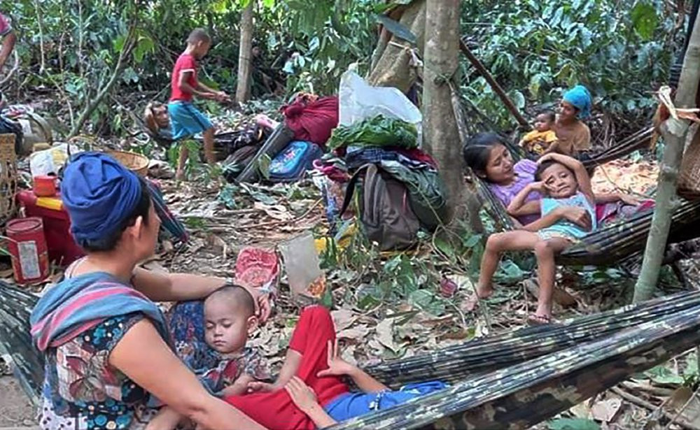 In this photo released by the Free Burma Rangers, Karen villagers gather in the forests as they hide from military airstrikes in the Deh Bu Noh area of the Papun district, north Karen state, 