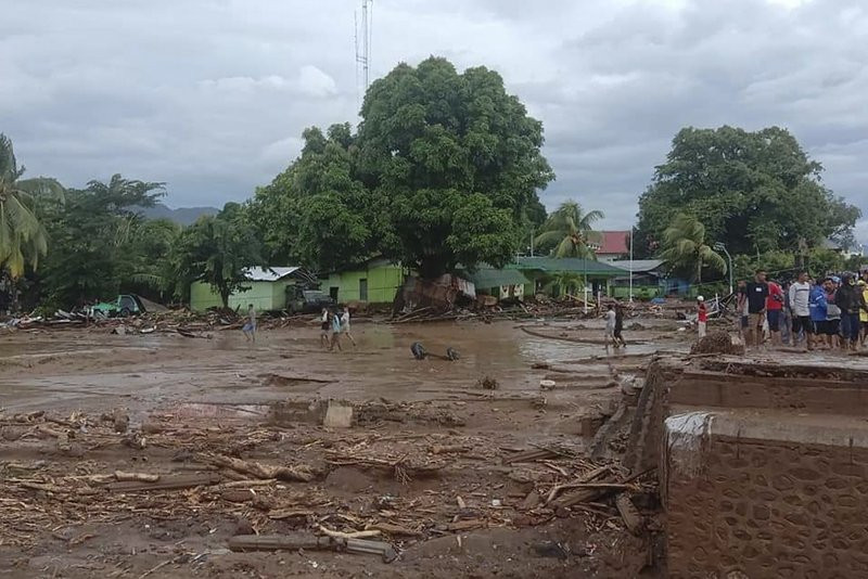Residents inspect the damage at a village hit by flash flood in East Flores, Indonesia, Sunday, April 4, 2021.