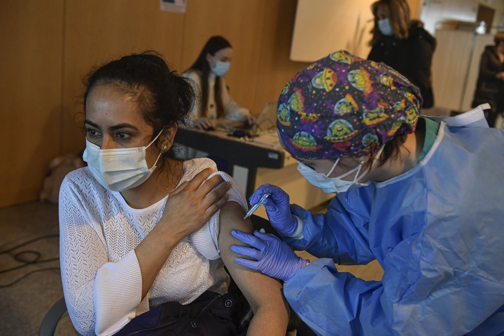 In this March 24, 2021 file photo, a woman receives a dose of the AstraZeneca COVID-19 vaccine, during a mass vaccination campaign at San Pedro Hospital, in Logrono, northern Spain.