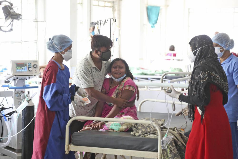 A woman cries after her husband died of a leakage in the oxygen plant of a hospital in Nashik.