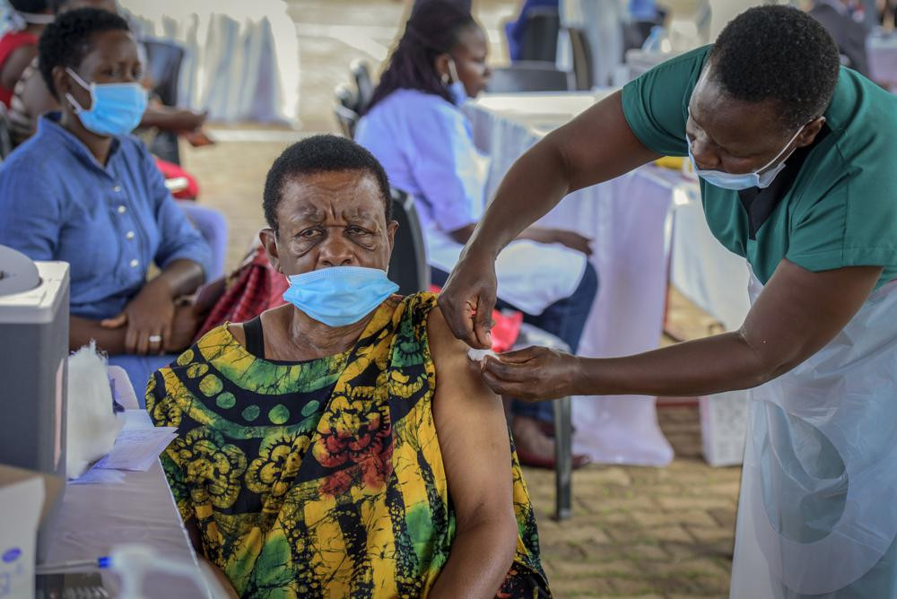 A woman receives a coronavirus vaccination at the Kololo airstrip in Kampala, Uganda, Monday, May 31, 2021.