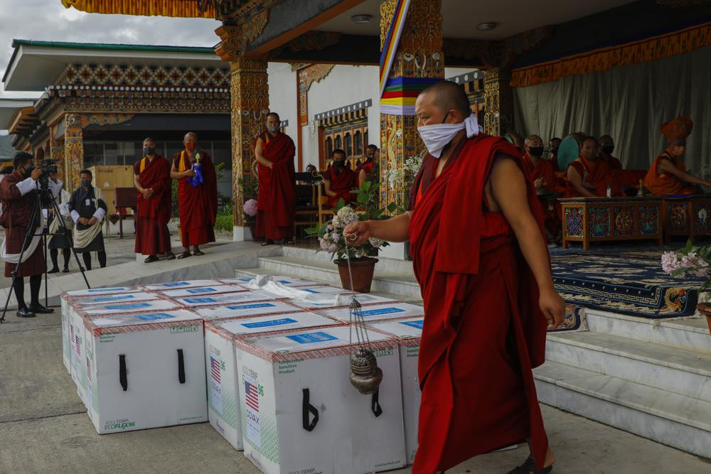 This photograph provided by UNICEF shows monks from Paro's monastic body perform a ritual as 500,000 doses of Moderna COVID-19 vaccine gifted from the United States arrived at Paro Internatio
