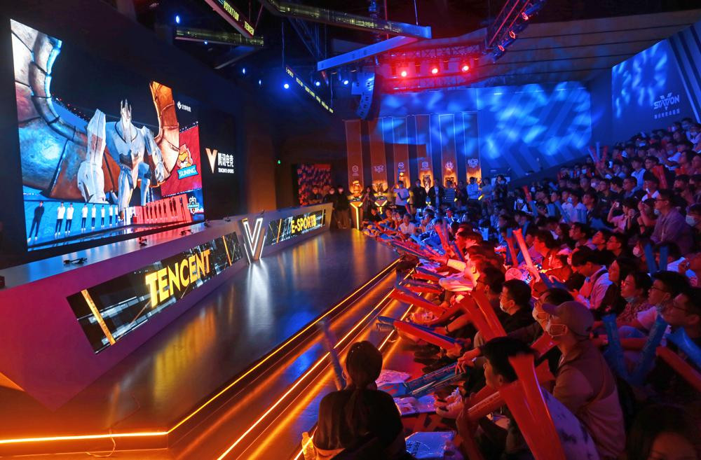 Fans watch the match of the 2020 League of Legends World Championship televised on a screen at a Tencent V-station in Shanghai, China, Oct. 31, 2020.