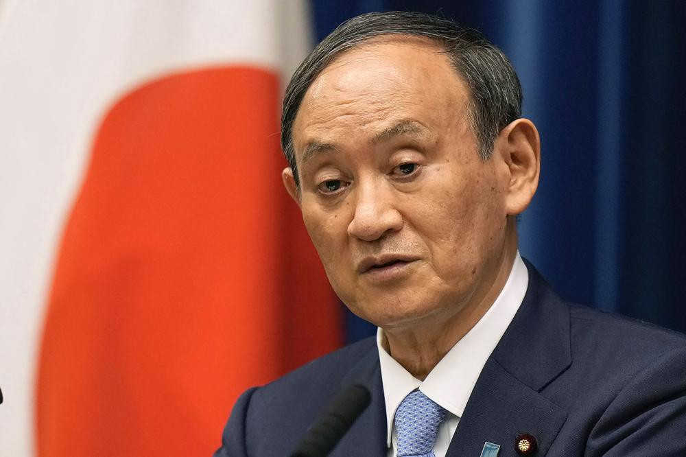 In this Aug. 17, 2021, file photo, Japanese Prime Minister Yoshihide Suga speaks during a news conference at prime minister's official residence in Tokyo.