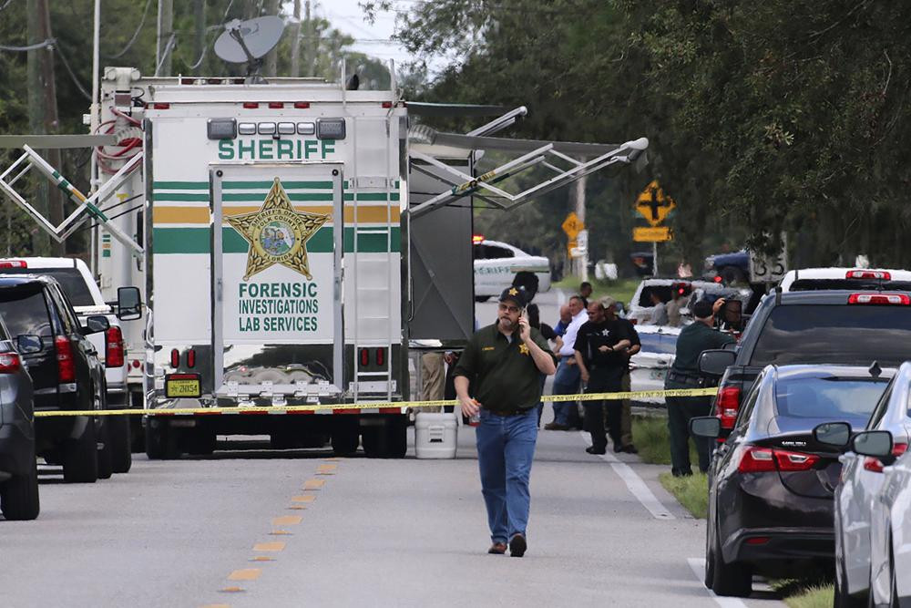 Polk County, Florida, Sheriff's officials work the scene of a multiple fatality shooting Sunday, Sept. 5, 2021, in Lakeland, Floridaa.