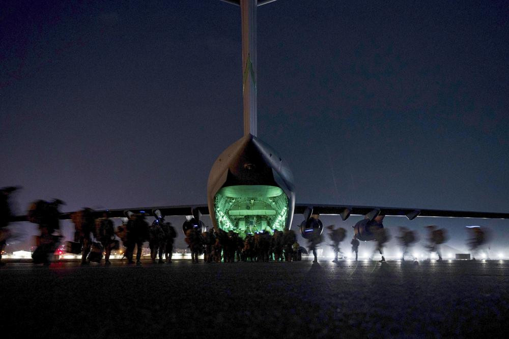 In this Aug. 30, 2021, file photo provided by the U.S. Air Force, soldiers, assigned to the 82nd Airborne Division, prepare to board a U.S. Air Force C-17 Globemaster III aircraft at Hamid Ka