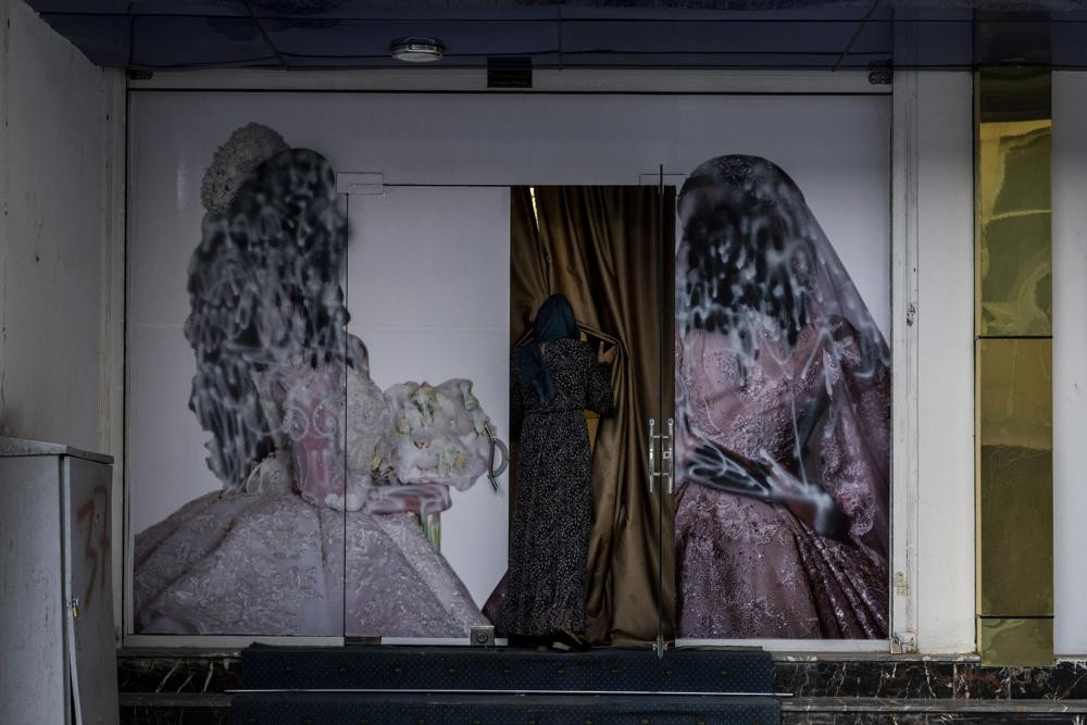 An Afghan woman enters a beauty salon in Kabul, Afghanistan, Saturday, Sept. 11, 2021. Since the Taliban gained control of Kabul, several images depicting women outside beauty salons have bee