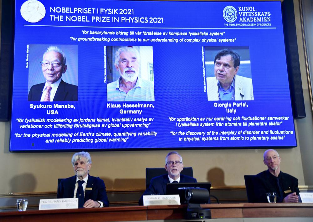 Secretary General of the Royal Swedish Academy of Sciences Goran Hansson, center, announces the winners of the 2021 Nobel Prize in Physics at the Royal Swedish Academy of Sciences, in Stockho