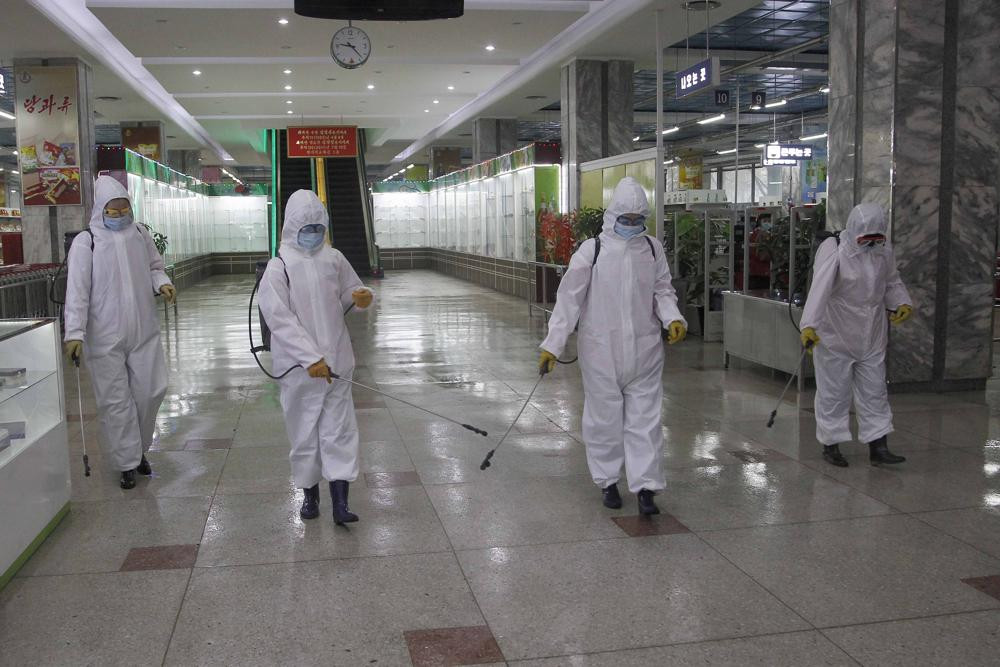 In this Dec. 28, 2020, file photo, staff of the Pyongyang Department Store No. 1 disinfect the store to help curb the spread of the coronavirus before it opens in Pyongyang, North Korea.