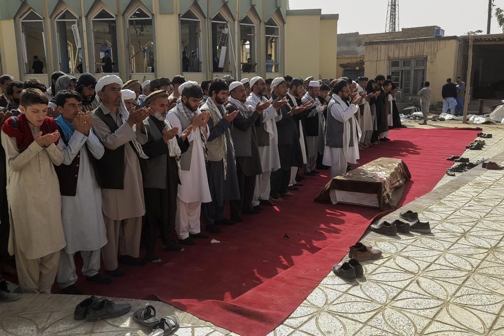 Relatives and residents pray during a funeral ceremony for victims of a suicide attack at the Gozar-e-Sayed Abad Mosque in Kunduz, northern Afghanistan, Saturday, Oct. 9, 2021.