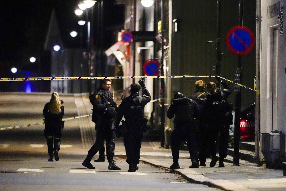 Police stand at the scene after an attack in Kongsberg, Norway, Wednesday, Oct. 13, 2021.