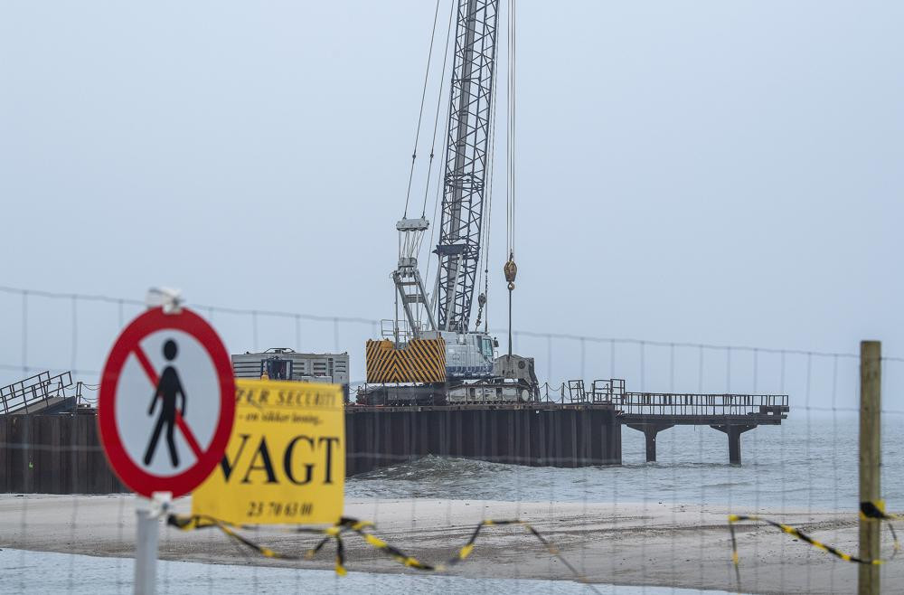 FILE - Construction work on a 200 meter long pier being built where the gas pipeline is due to come ashore at Houstrup Strand, in West Jutland, Denmark, Tuesday Feb. 23, 2021.