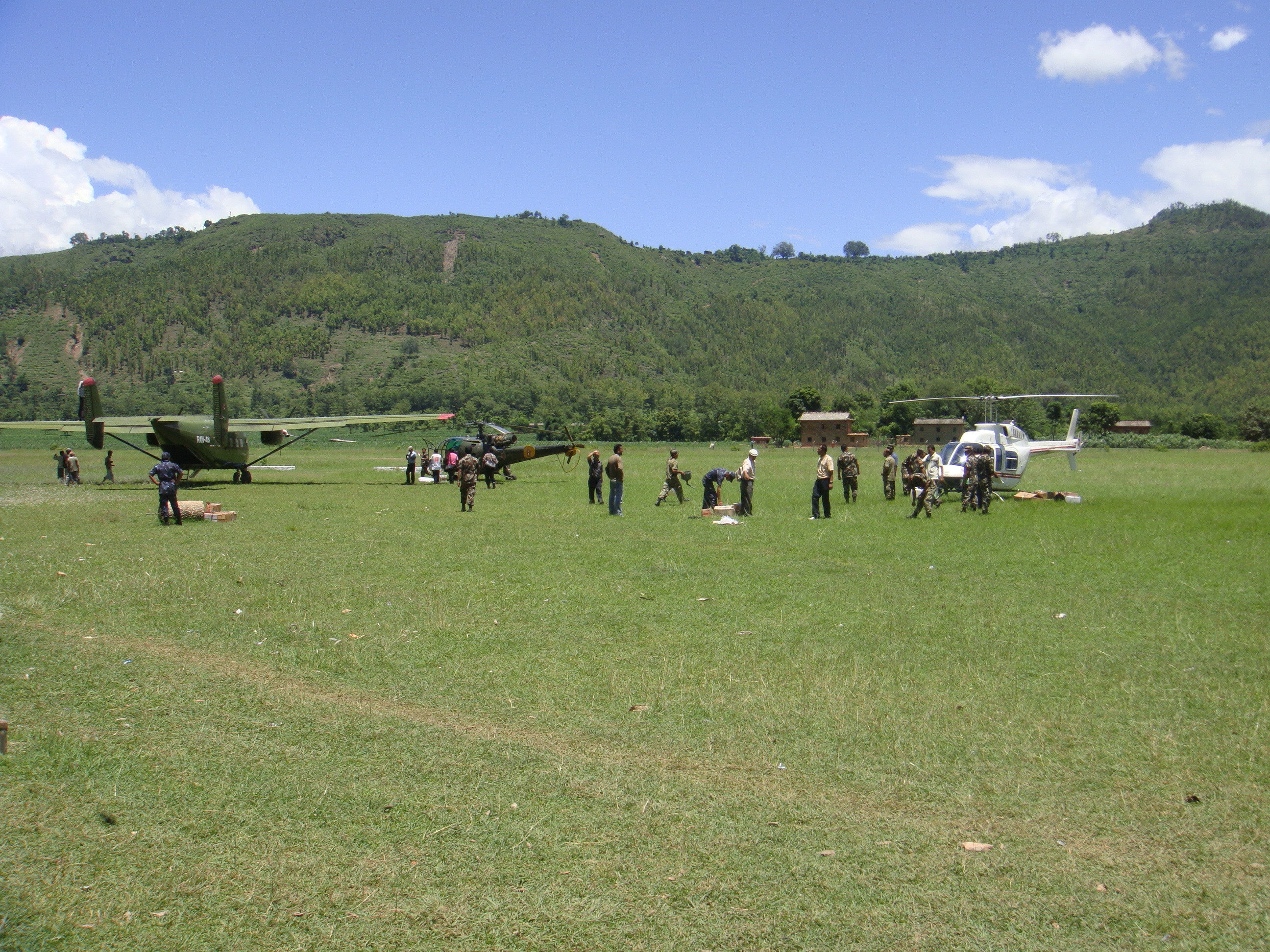 Relief and rescue workers unloading essential medical supplies at the Chaurjhari airstrip, Rukum in response to the diarrhea outbreak in Jajarkot during 2009 monsoon.