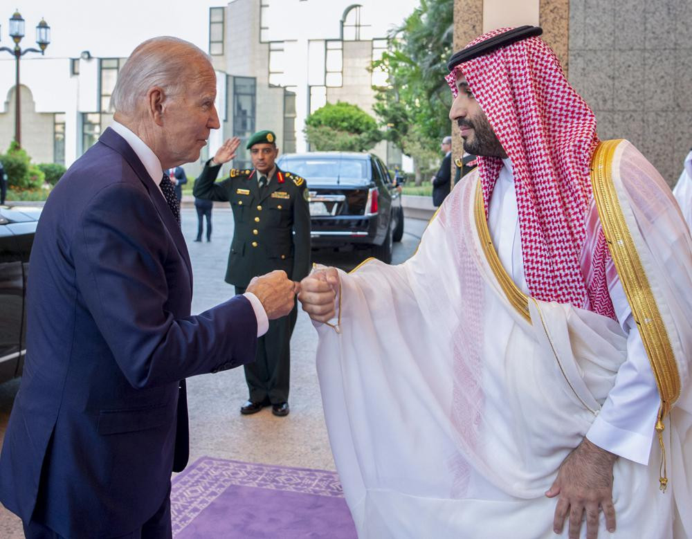 In this image released by the Saudi Royal Palace, Saudi Crown Prince Mohammed bin Salman, right, greets US President Joe Biden with a fist bump after his arrival at Al-Salam palace in Jeddah,