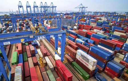 In this May 14, 2019, fiel photo, containers are piled up at a port in Qingdao in east China's Shandong province.