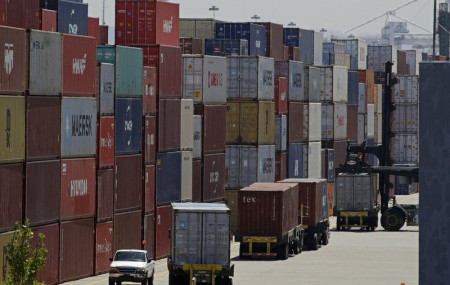 In this July 22, 2019, file stacked containers wait to be loaded on to trucks at the Port of Oakland in Oakland, California.