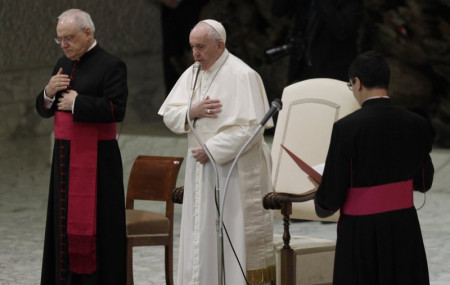 Pope Francis, center, makes the sign of the cross during his weekly general audience in the Paul VI hall at the Vatican, Wednesday, Oct. 21, 2020.