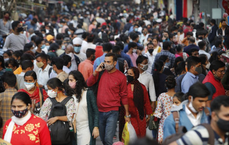 People throng a market to shop ahead of the Diwalli festival in New Delhi, India, Thursday, Nov. 12, 2020.